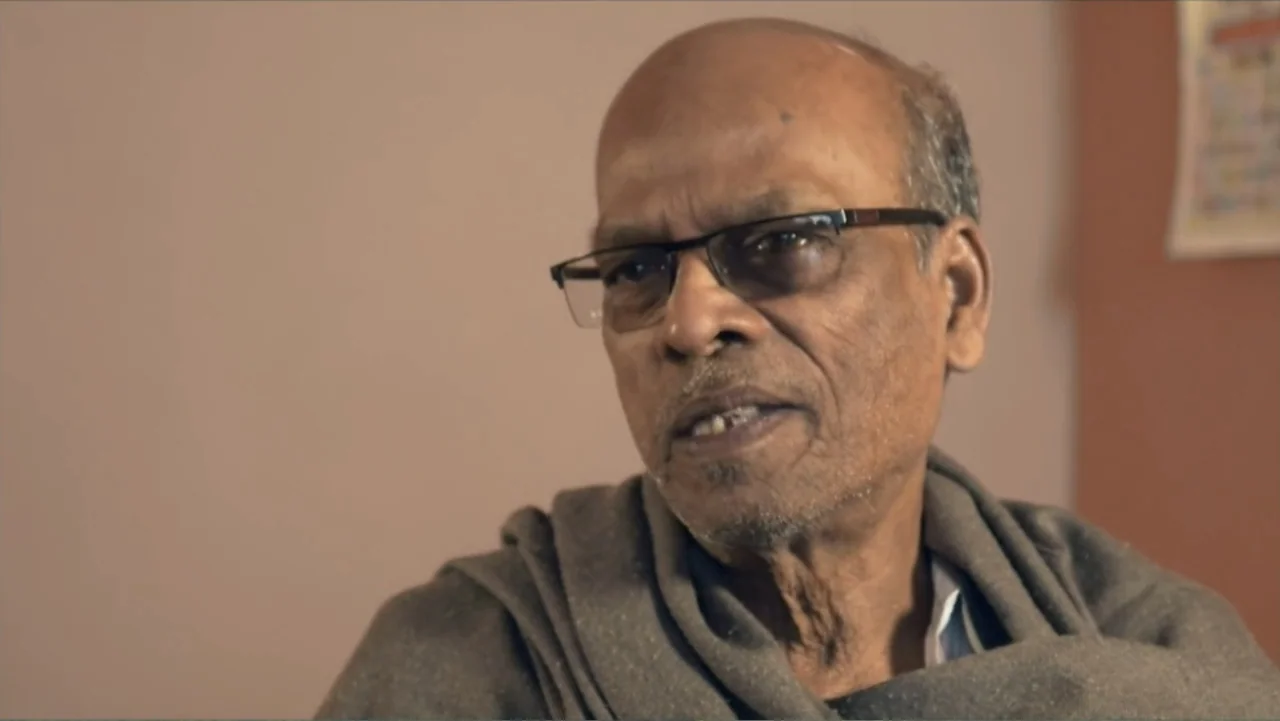 Hare Krishna! The Mantra, the Movement and the Swami Who Started It All (2017) movie still: closeup — An interior space with a plain, light-toned…