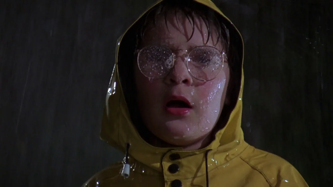 Friday the 13th: A New Beginning (1985) movie still: closeup — A dark night with heavy rainfall against a featureless background. A young boy in a…