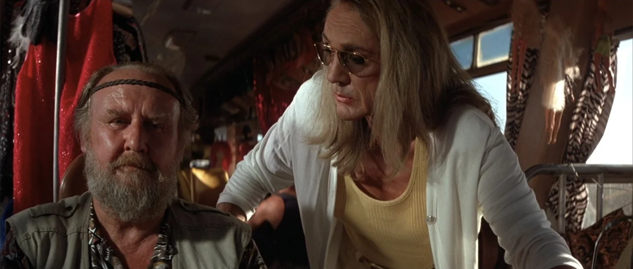 The Adventures of Priscilla, Queen of the Desert (1994) movie still: medium — A cluttered interior of a motorhome with patterned curtains and…