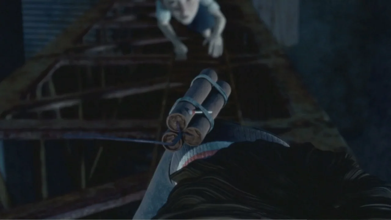 Monster House (2006) movie still: closeup — A dark rusted metal frame structure spans across the frame at night. Three sticks of dynamite tied…