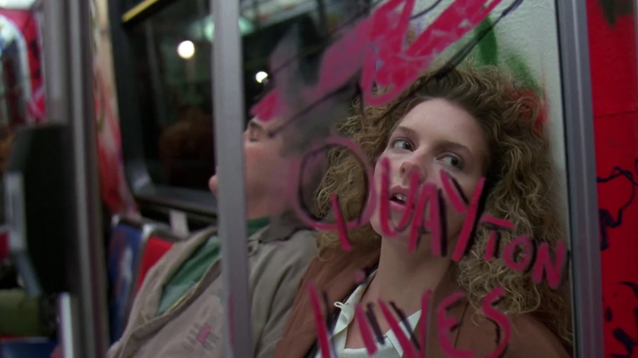 Friday the 13th Part VIII: Jason Takes Manhattan (1989) movie still: medium — A dimly lit subway car at night features graffiti marked on the window…