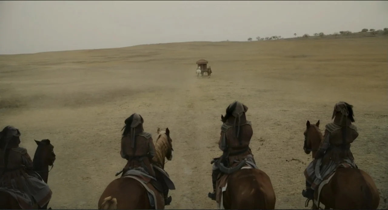 Legends of the Condor Heroes: The Gallants (2025) movie still: wide — A group of four riders travel across a vast, dusty, open dry plain. In the…