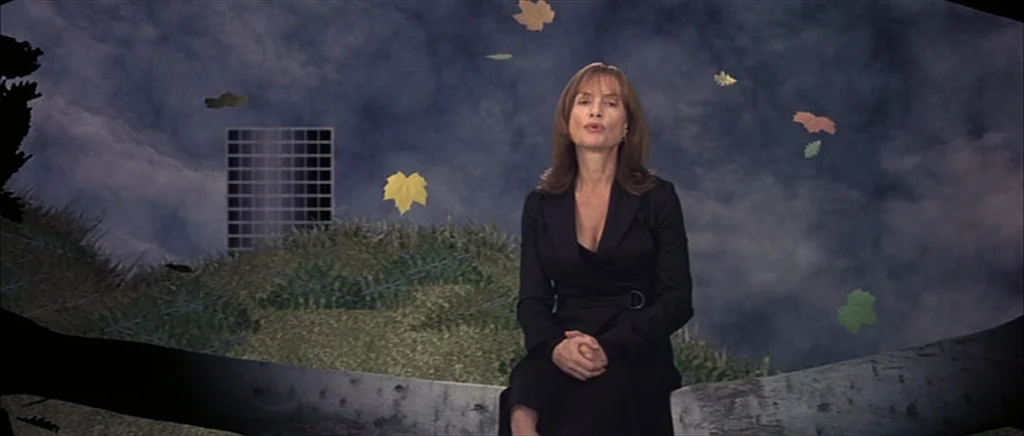I Heart Huckabees (2004) movie still: medium — A woman sits on a large fallen tree trunk against a surreal, dark backdrop. Floating colorful autumn…