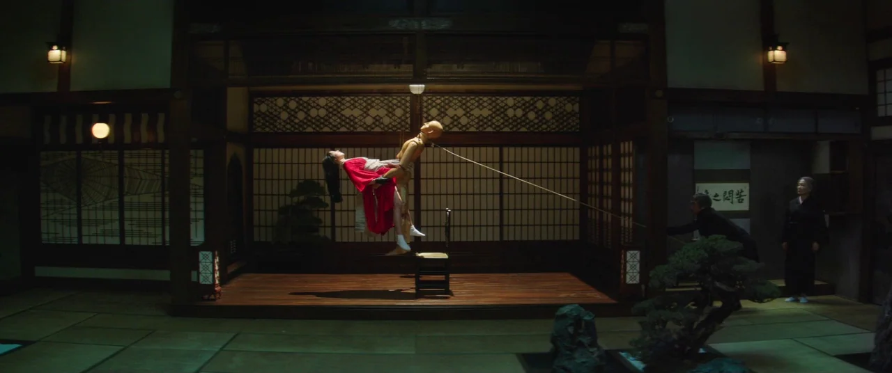 The Handmaiden (2016) movie still: wide — A traditional Japanese room features tatami flooring and paper sliding doors on a platform. A woman in a…