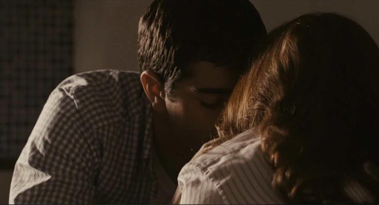 Beyond a Reasonable Doubt (2009) movie still: closeup — A dimly lit interior space with soft, directional light hitting two people's profiles. A man…