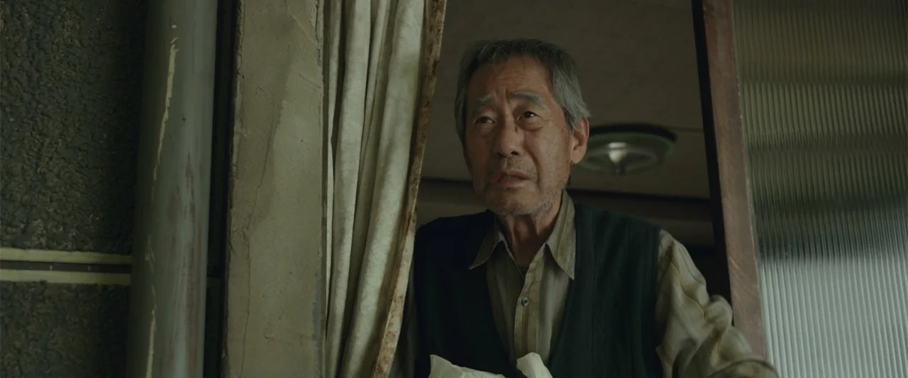 Along with the Gods: The Last 49 Days (2018) movie still: medium — A dimly lit residential interior features a doorway draped with a beige curtain.…
