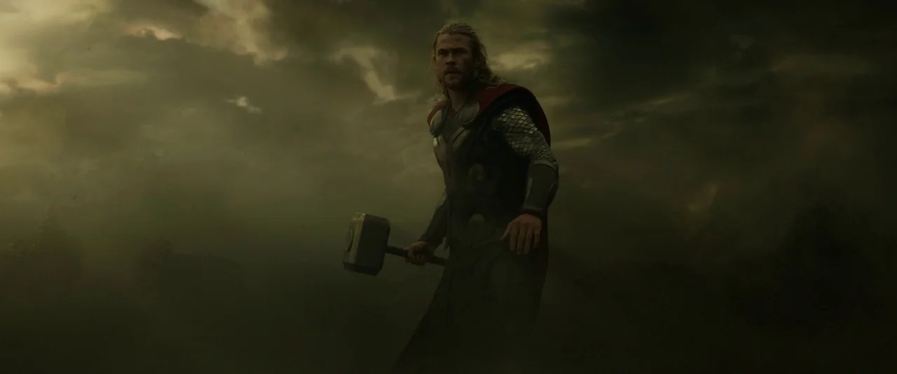 Thor: The Dark World (2013) movie still: fullbody — A dark, ominous landscape filled with thick, swirling storm clouds obscures the horizon line. A…