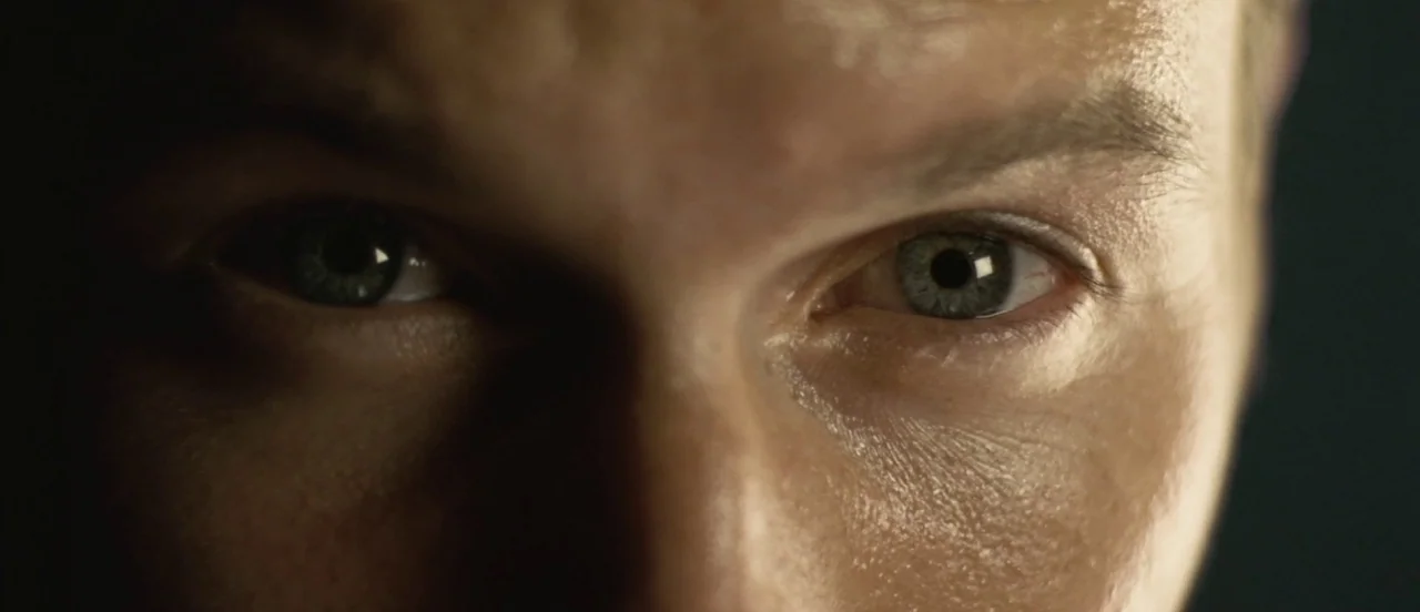 Hard Candy (2005) movie still: closeup — Extreme closeup of a man's eyes and upper face in a darkened environment. The subject looks directly into…