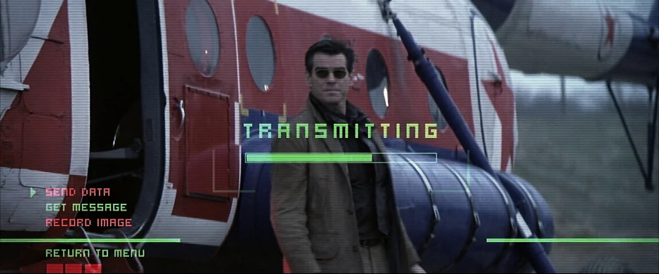 Die Another Day (2002) movie still: medium — A man stands before a parked helicopter marked with a red Soviet-style star. The image is overlaid with…