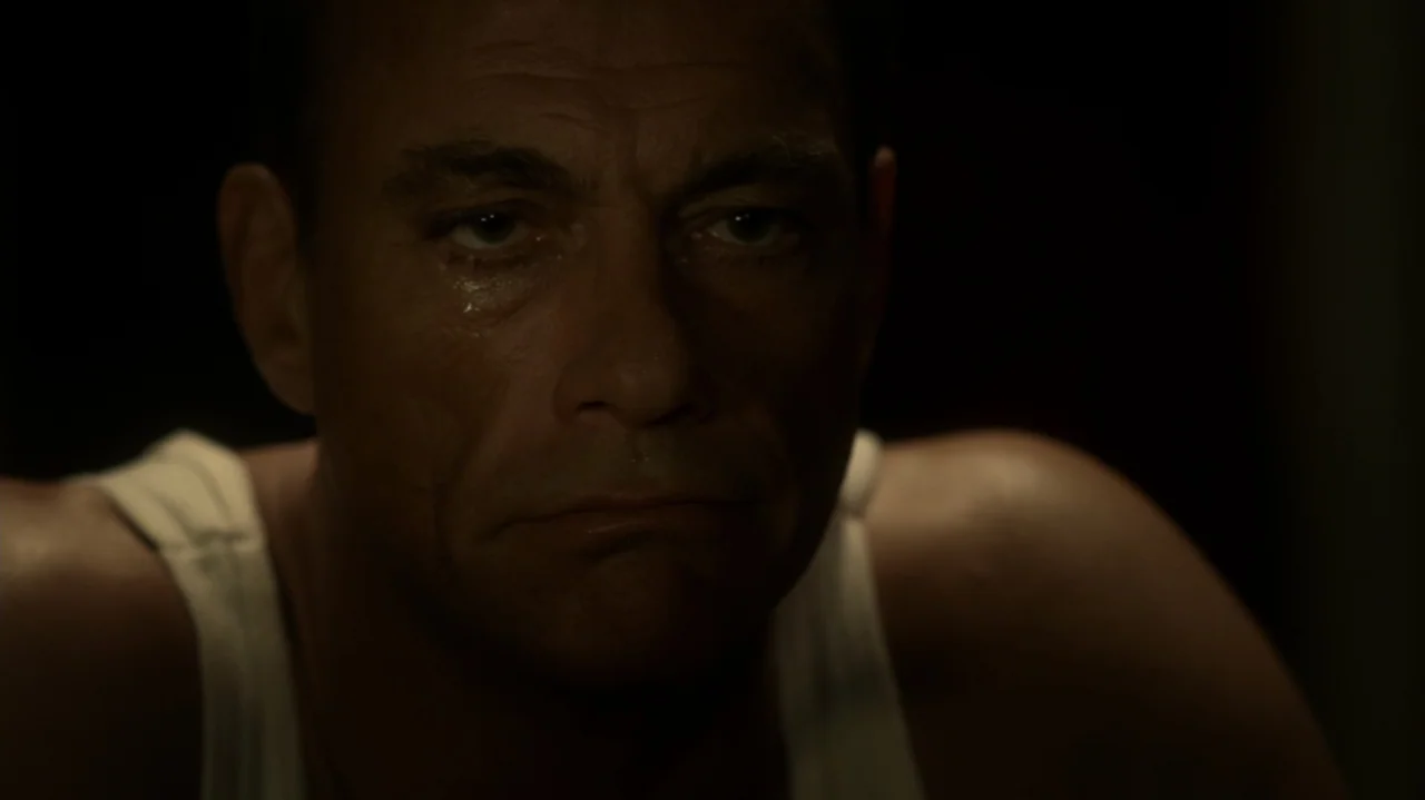 6 Bullets (2012) movie still: closeup — A dark, nondescript interior space provides the backdrop for a close portrait. A middle-aged man in a white…