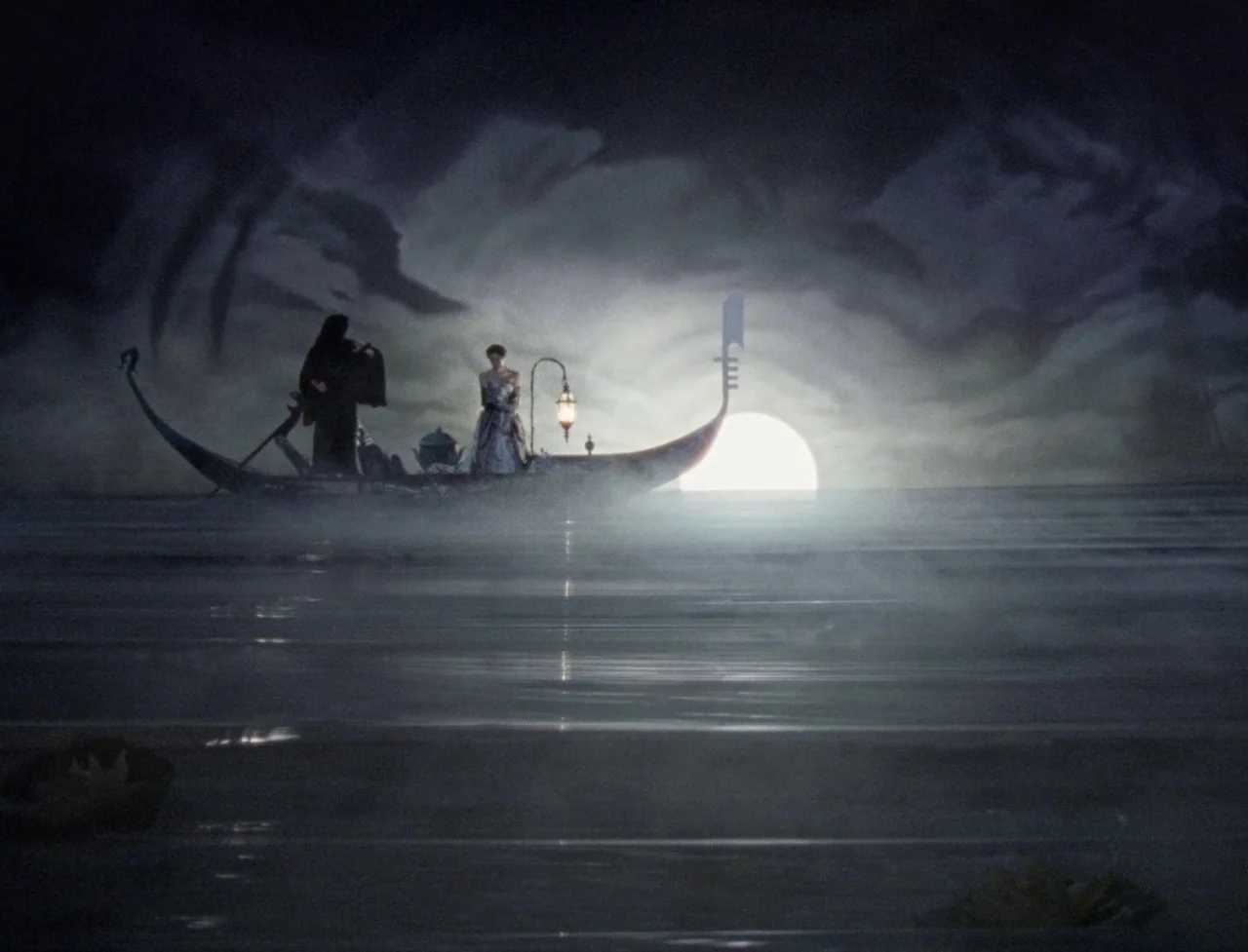 The Souvenir: Part II (2021) movie still: wide — A dark gondola traverses across a flat, fog-covered body of water at night. Two silhouetted figures…