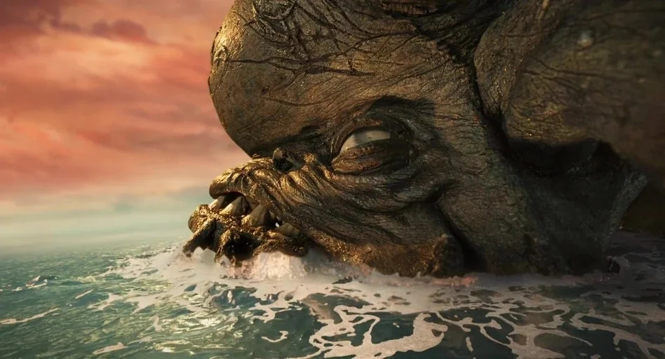 Guillermo del Toro’s Pinocchio (2022) movie still: closeup — A massive creature with leathery skin rests partially submerged in open calm water. The…