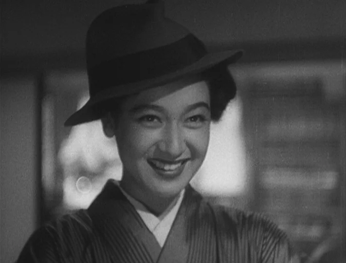 No Regrets for Our Youth (1946) movie still: closeup — An interior space features a woman framed in a close-up shot. The woman wears a patterned…