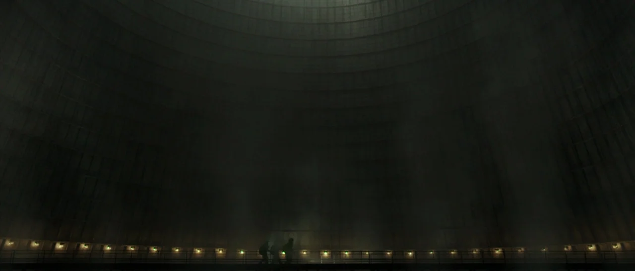 Blackhat (2015) movie still: wide — The massive, curved concrete interior of a cooling tower looms over a narrow catwalk. Small figures in dark…