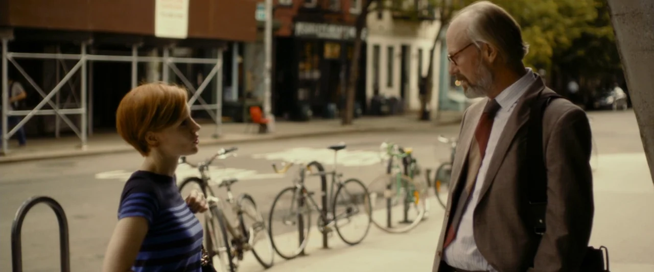 The Disappearance of Eleanor Rigby: Her (2014) movie still: medium — A city sidewalk next to a bike rack with several bicycles parked against it. A…