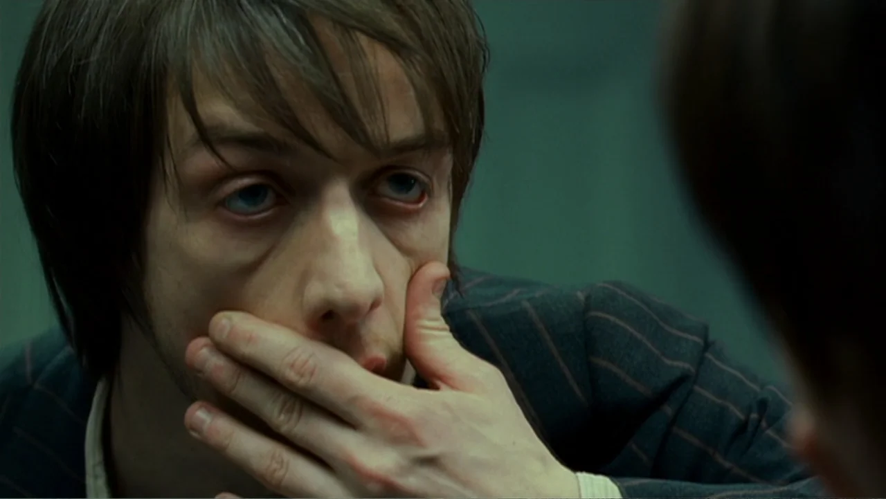 Penelope (2007) movie still: closeup — A stark interrogation room with nondescript green walls serves as the backdrop. A pale young man with dark…
