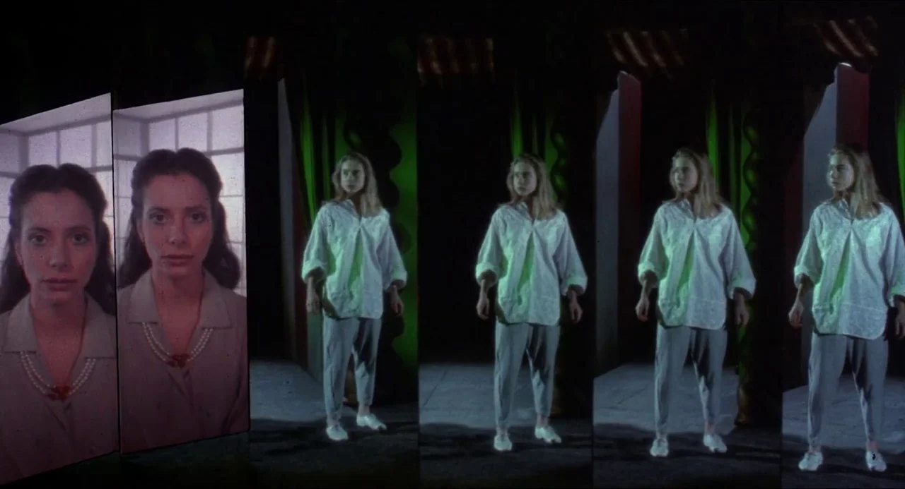 Hellbound: Hellraiser II (1988) movie still: wide — A dark stage features tall panels projecting images of a woman in a necklace. The central figure…
