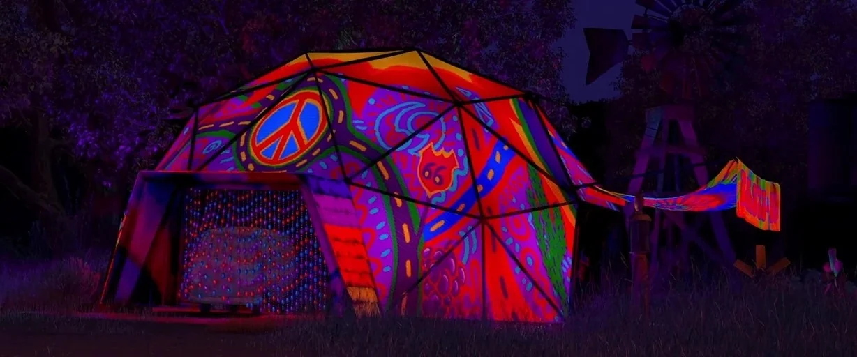 Cars (2006) movie still: wide — A geodesic dome tent decorated with colorful psychedelic peace signs and Route 66 motifs. A windmill stands in the…