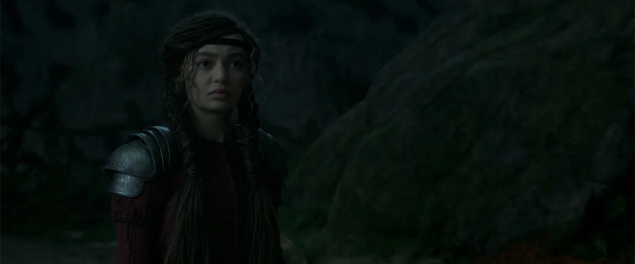 How to Train Your Dragon (2025) movie still: medium — A dark, uneven natural landscape featuring massive rock formations under dim evening light. A…