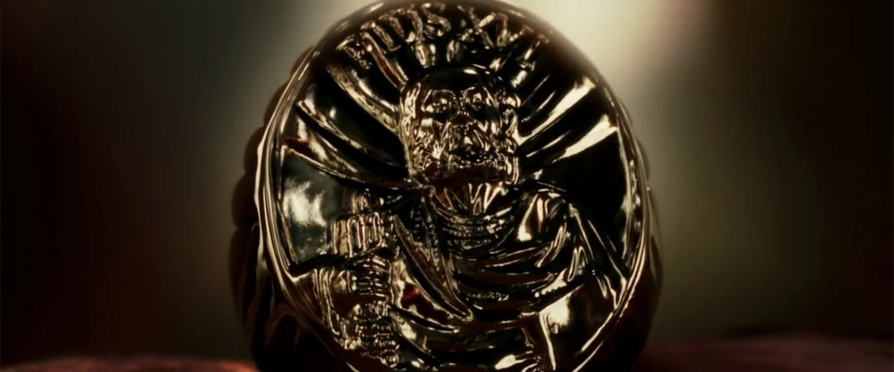 Angels & Demons (2009) movie still: closeup — A close-up shot focuses on a polished golden signet ring with an embossed figure. The ring rests…