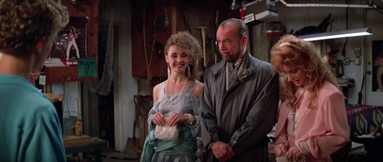 Bill and Ted’s Excellent Adventure (1989) movie still: medium — A cluttered suburban garage filled with tools and hanging nets under fluorescent…