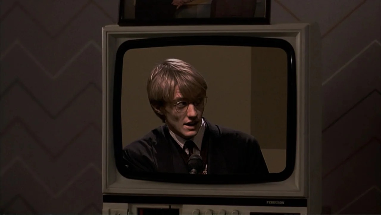 Starter for 10 (2006) movie still: closeup — A man appears on the screen of an old television set in a dark room. The television is the central…