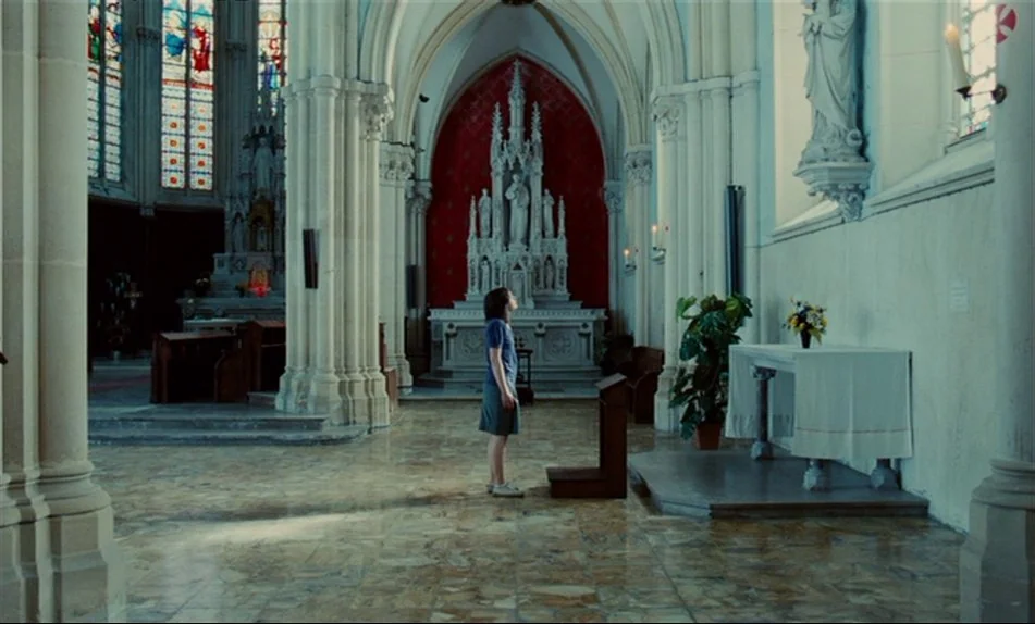 Hadewijch (2009) movie still: wide — An expansive, high-ceilinged stone church interior features intricate vaulted architecture and a central altar.…
