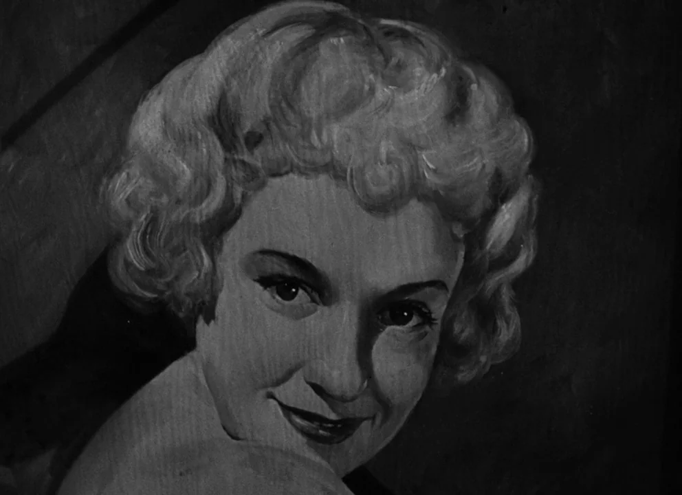 Citizen Kane (1941) movie still: closeup — A portrait painting on canvas depicts a woman with blonde hair. The subject gazes directly forward from…