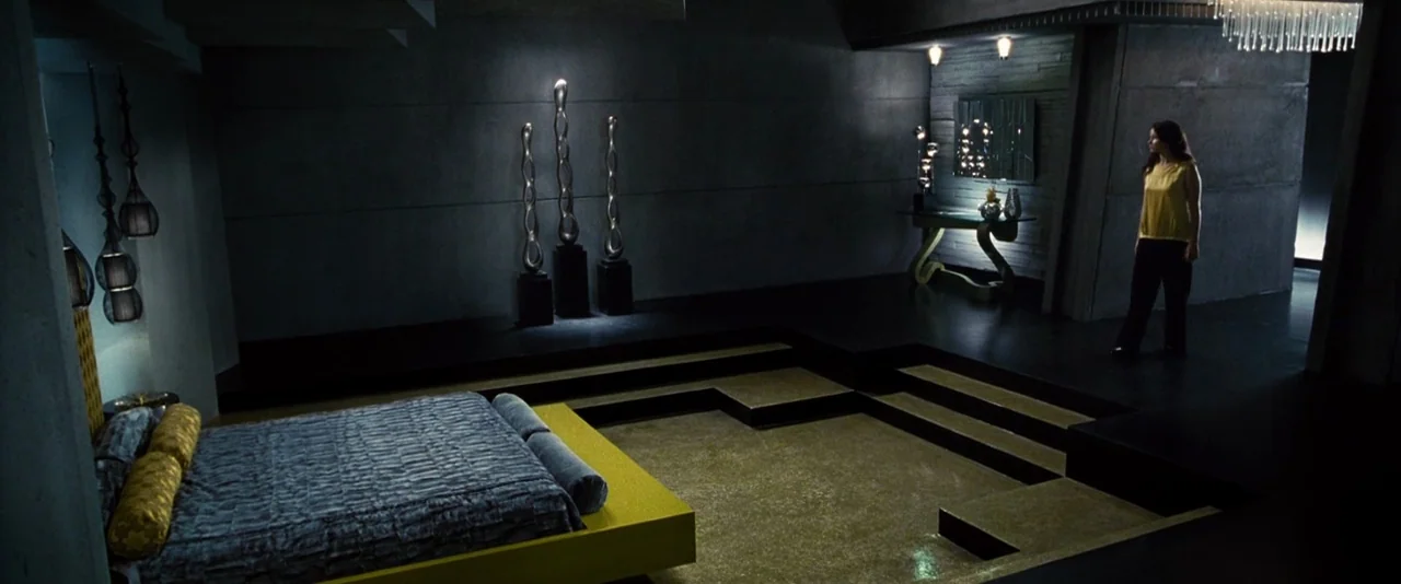 The Hunger Games (2012) movie still: wide — A spacious, multi-level modern apartment features dark concrete walls and minimalist geometric decor…