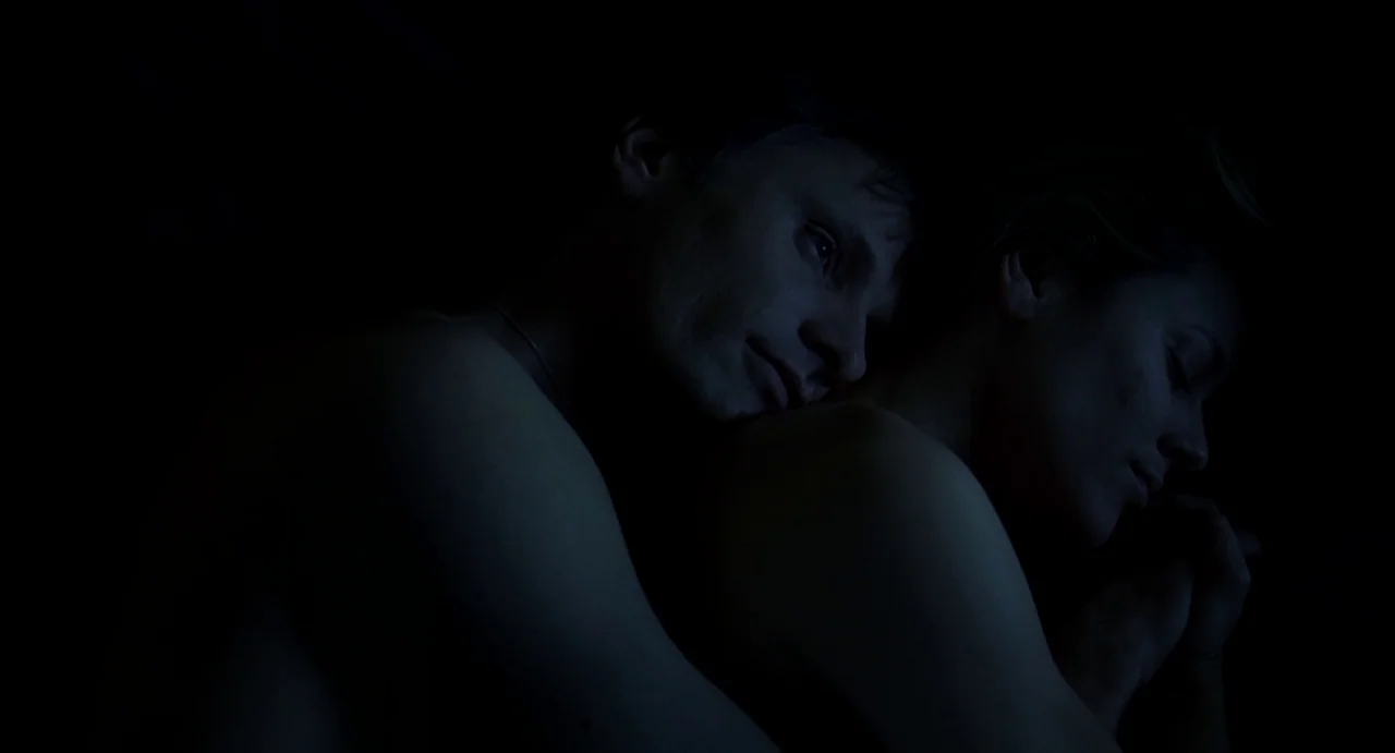 A History of Violence (2005) movie still: medium — A dark, shadows-only interior setting featuring two people resting together in bed. A man with…