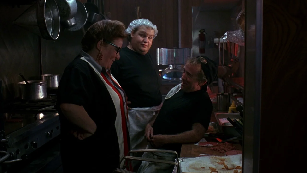Jason Goes To Hell (1993) movie still: medium — A dimly lit commercial kitchen contains stainless steel appliances and hung metal cooking utensils.…