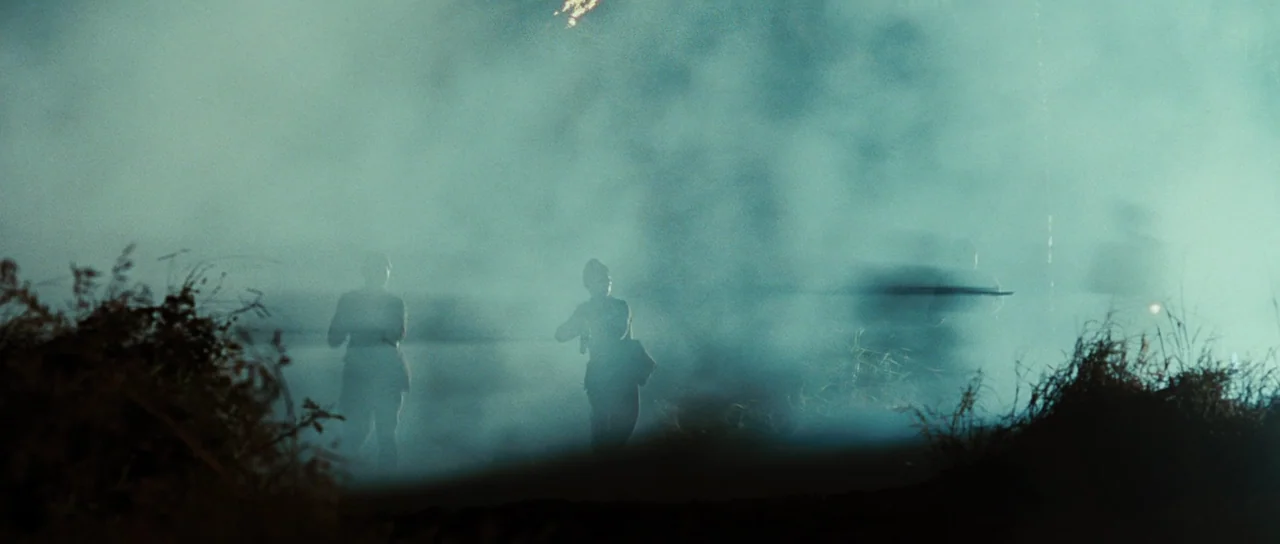 Australia (2008) movie still: wide — A field filled with heavy grey smoke obscures the surroundings. Two soldiers in uniform move forward through…