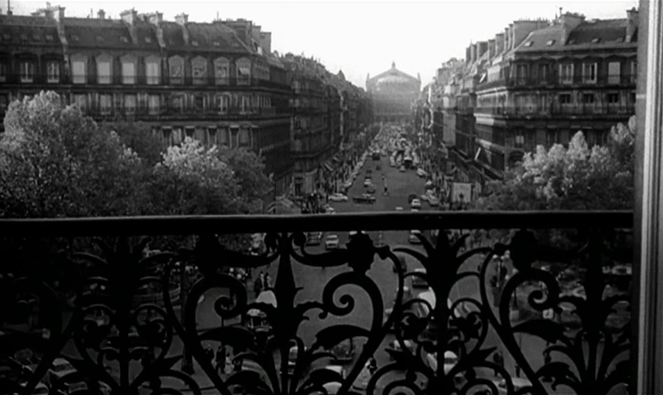 Thérèse Desqueyroux (1962) movie still: establishing — A view of a Parisian boulevard from a balcony with wrought iron railings. Tall…