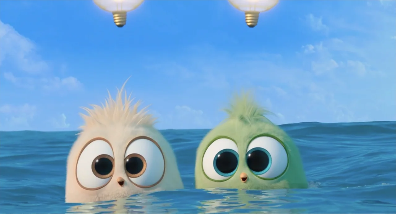 The Angry Birds Movie 2 (2019) movie still: medium — Two small, round, fluffy cartoon birds float in open blue water under a bright sky. The birds…