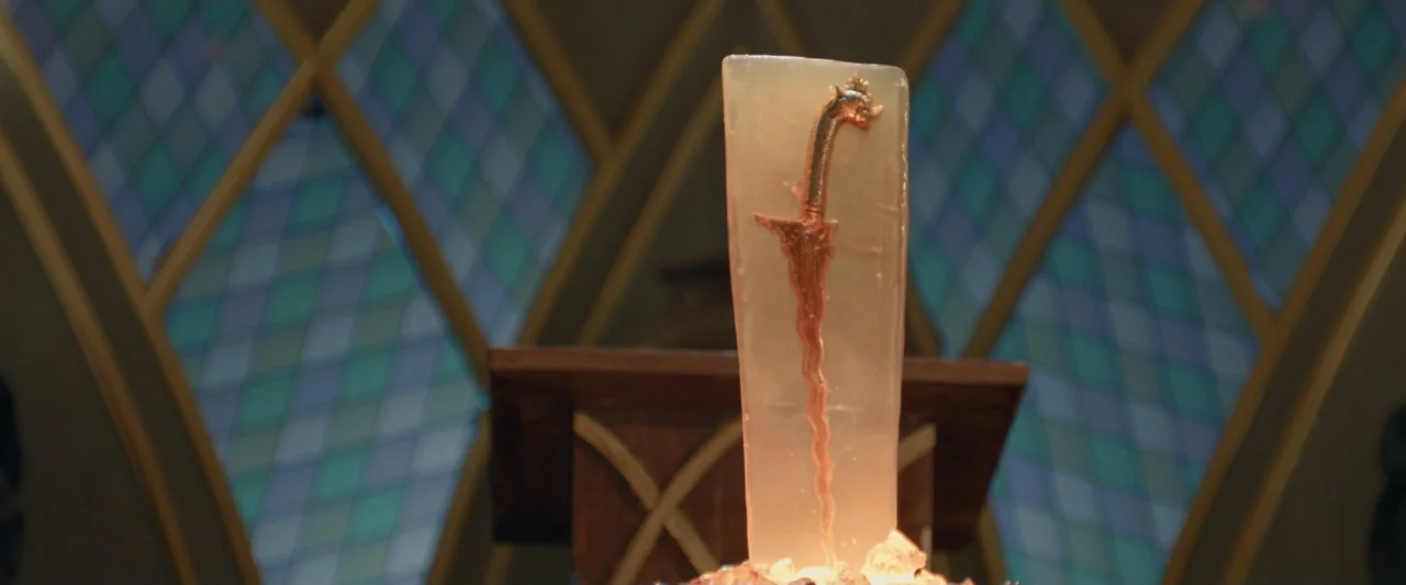 The Chanting 3 (2008) movie still: closeup — A decorative dagger is suspended inside a translucent block on a wooden pedestal. Intricate…