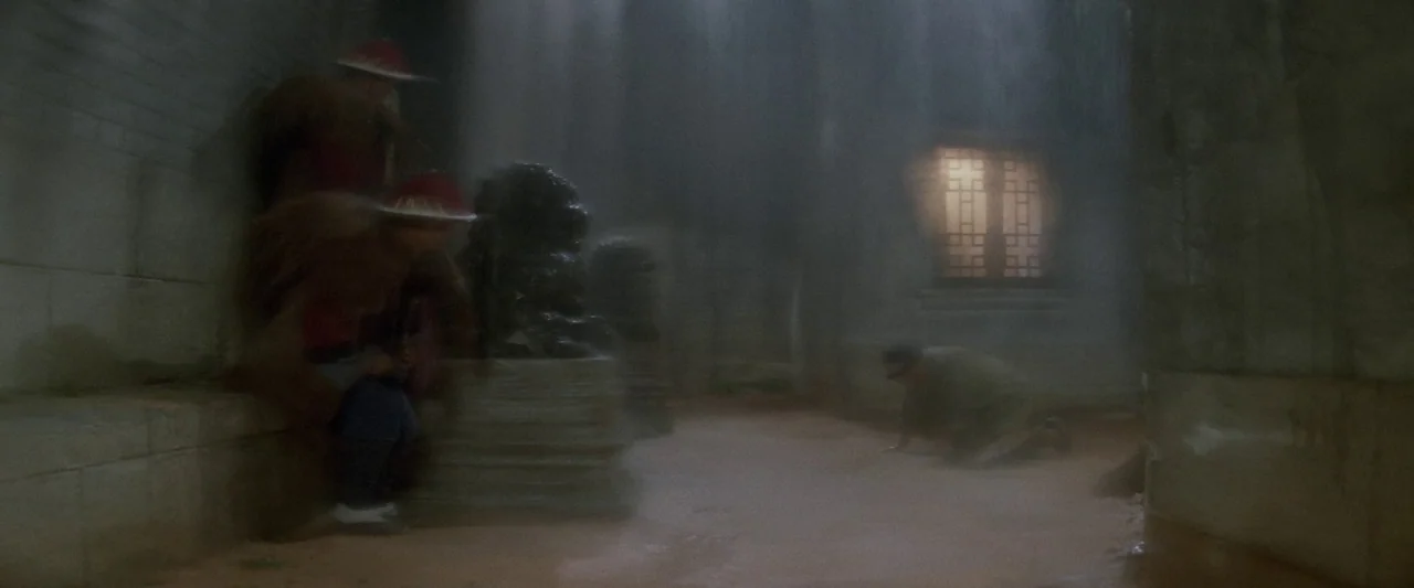 Once Upon a Time in China (1991) movie still: wide — A dim, moisture-filled stone hall features a single glowing lattice window in the distance. Two…