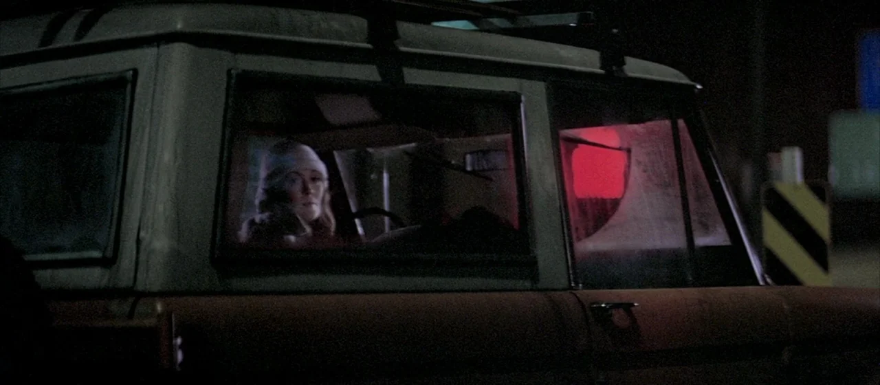 Three Days of the Condor (1975) movie still: medium — A dark night exterior features the side profile of a vintage truck parked outdoors. A young…