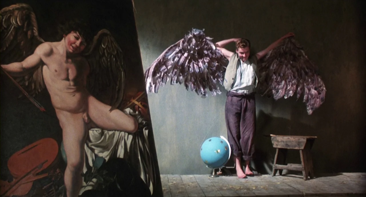Caravaggio (1986) movie still: fullbody — A workshop contains a large easel holding a classical painting of an angel. A young man wearing large…