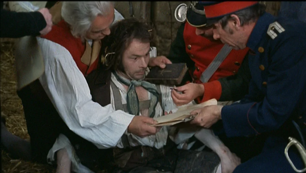The Enigma Of Kaspar Hauser (1974) movie still: medium — A group of men in 19th-century attire sit within a structure containing dry straw. A man in…