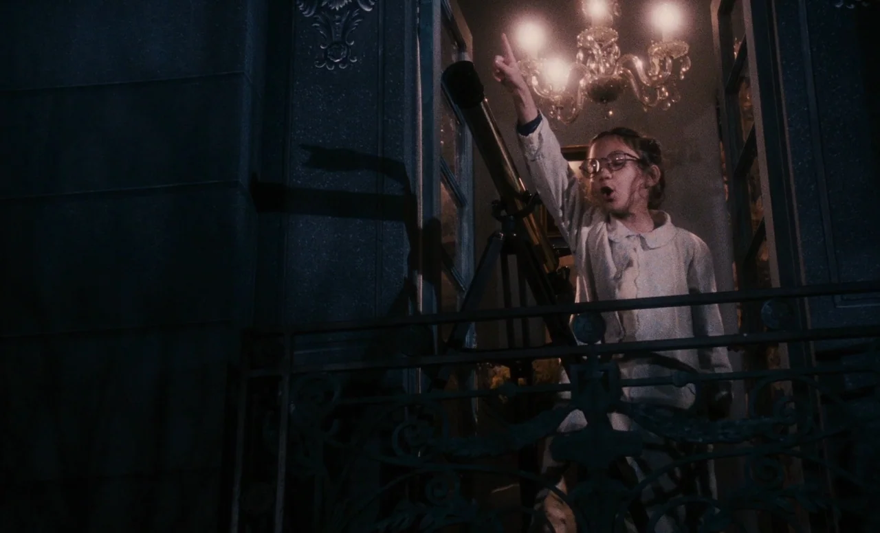 James and the Giant Peach (1996) movie still: medium — A child stands on an ornate metal balcony at night with a telescope. She points towards the…