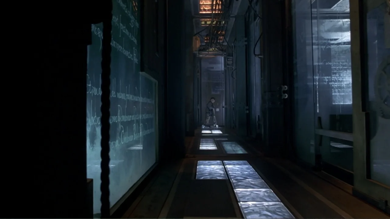 13 Ghosts (1960) movie still: wide — A long, dark corridor features glass walls covered in handwritten white text. A lone child stands at the far…