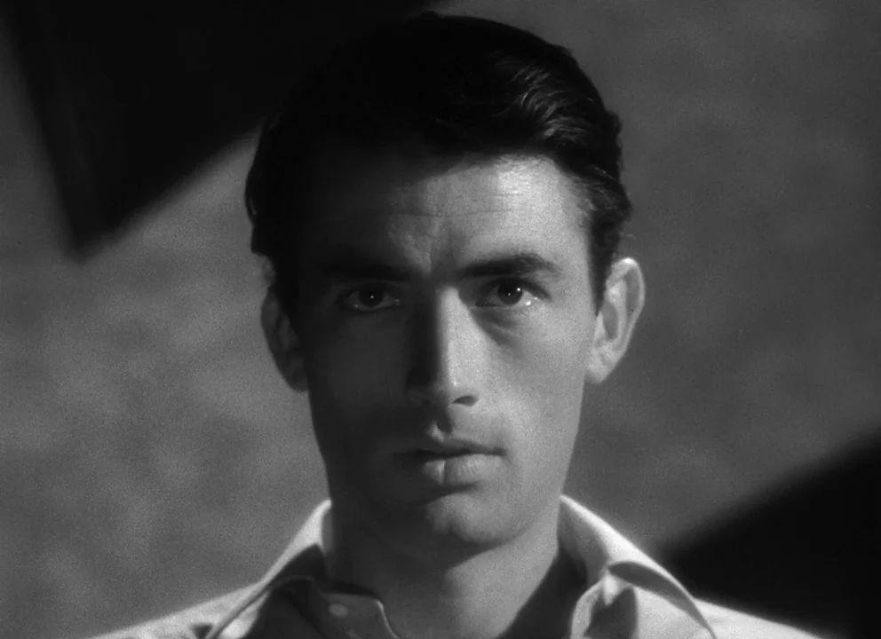Spellbound (1945) movie still: closeup — A close-up portrait of a man set against a dark, featureless background. The subject faces the camera…