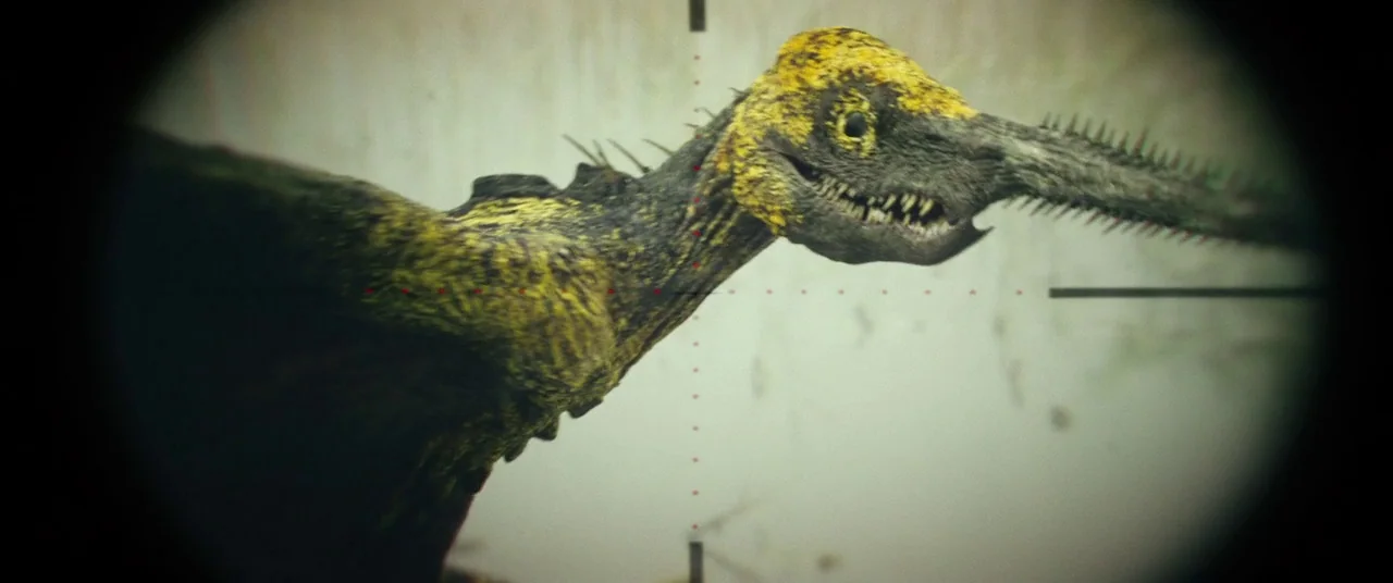 Kong: Skull Island (2017) movie still: closeup — A reptilian creature with yellow and black textured scales moves through a hazy environment. The…