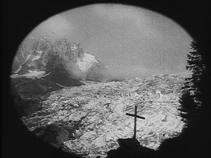 Making of: The Wheel (La Roue) (1923) movie still: establishing — A high-altitude mountainous landscape features a vast ice field under a clear sky.…
