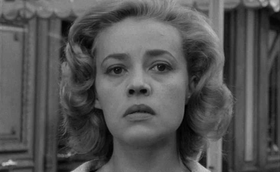 Elevator To The Gallows (Ascenseur pour l’échafaud) (1958) movie still: closeup — An outdoor fairground setting with wooden structures visible in…