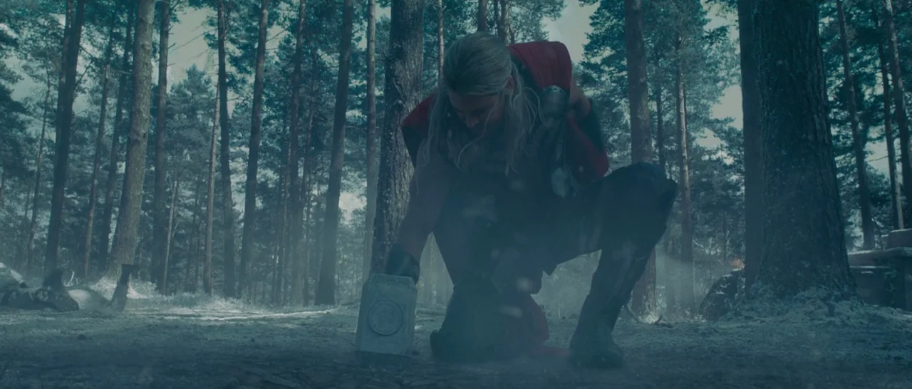 Avengers: Age of Ultron (2015) movie still: medium — A dense pine forest with a light dusting of snow on the ground. A muscular blonde man kneels on…