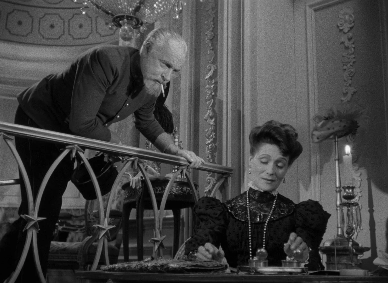 Letter From An Unknown Woman (1948) movie still: medium — A refined interior setting features an ornate railing and decorative wall molding. An…