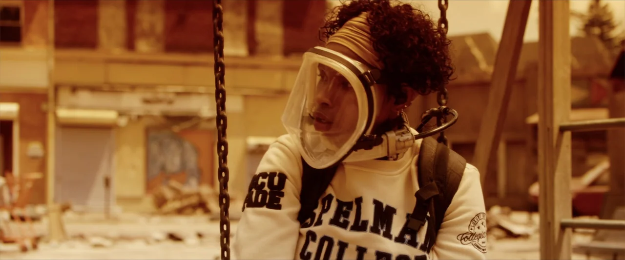 Breathe (2011) movie still: medium — A post-apocalyptic playground features rusted equipment and debris-strewn ground in an urban setting. A young…