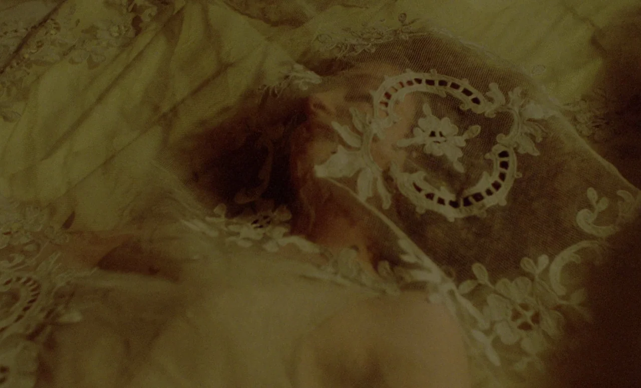 The Strange Case of Dr. Jekyll and Miss Osbourne (1981) movie still: closeup — A close-up view shows a person lying down with lace covering their…