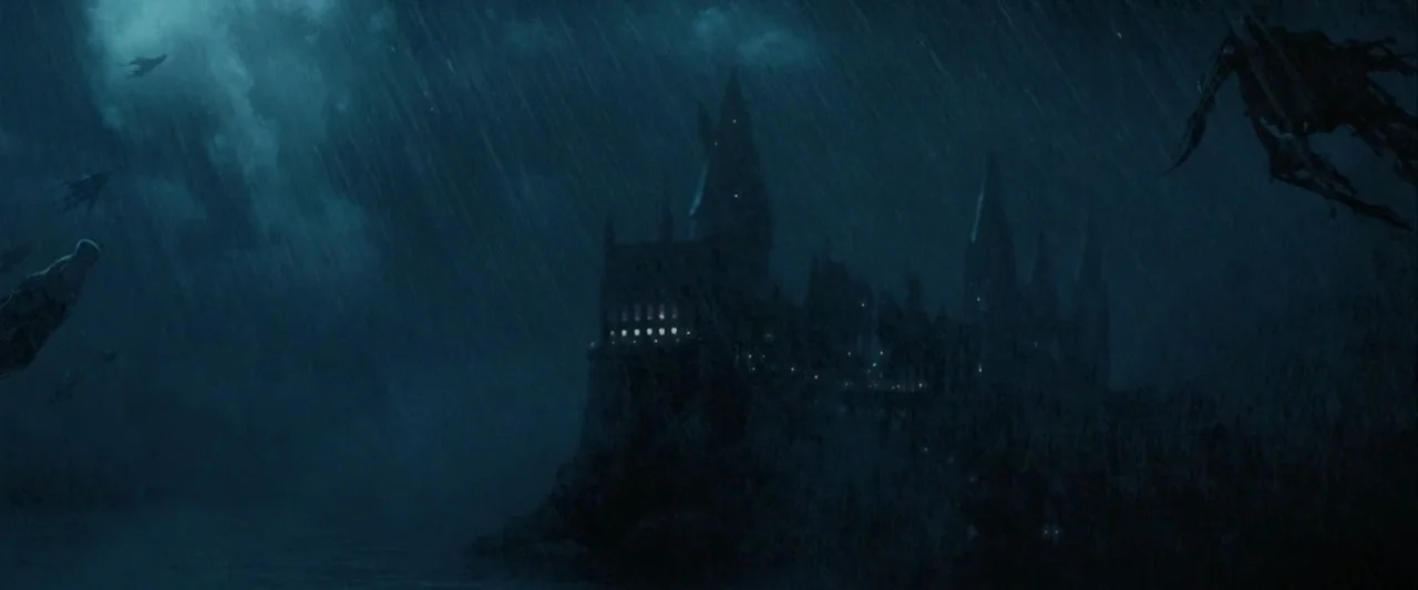 Harry Potter and the Prisoner of Azkaban (2004) movie still: establishing — A dark stone castle sits on a cliffside during a heavy rainstorm at…